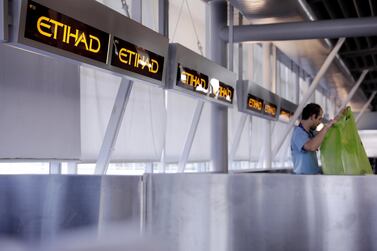 A worker cleans Etihad airlines counters at JFK International Airport in New York, U.S., March 21, 2017. Reuters