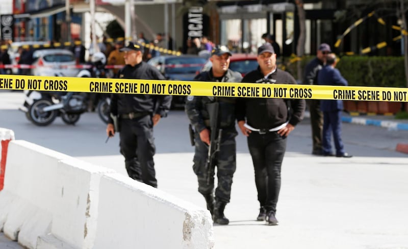 Police officers stand guard at the site of a suicide attack near the U.S. embassy in Tunis, Tunisia. REUTERS