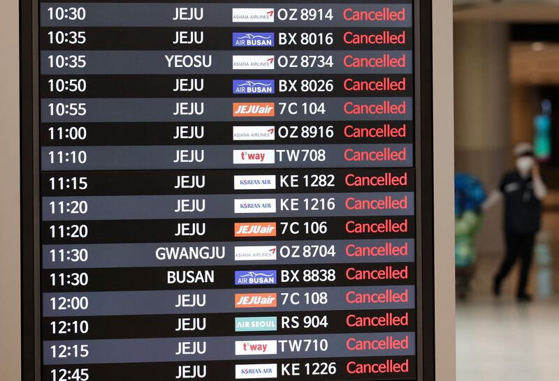 An electronic board shows the cancellations of domestic flights due to approaching typhoon at the arrival hall of the Gimpo Airport in Seoul, South Korea.  AP