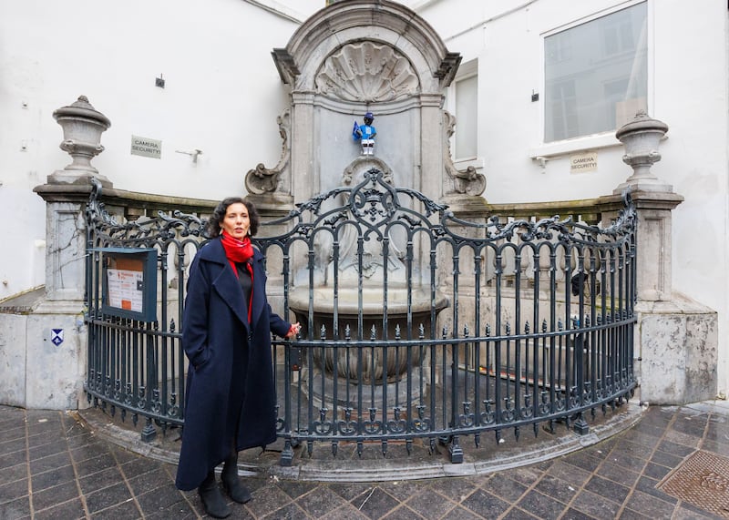 Ms Lahbib with the iconic Manneken-Pis, known as Manneken-Peace, dressed in a NATO uniform, in Brussels. PA