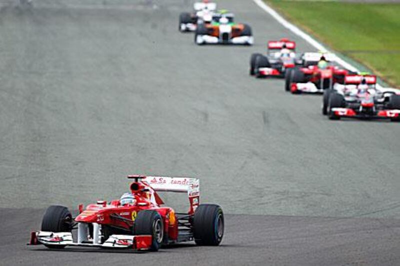 Fernando Alonso leads a pack of four at the Silverstone race track in Northamptonshire.