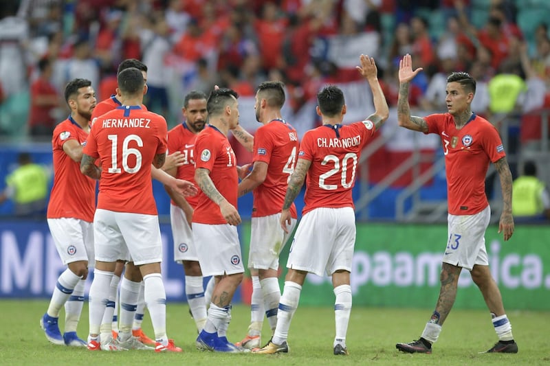 Chile players congratulate each other after defeating Ecuador. AFP