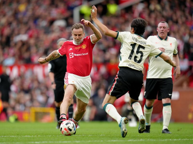 United's Karel Poborsky battles for the ball with Liverpool's  Yossi Benayoun. PA
