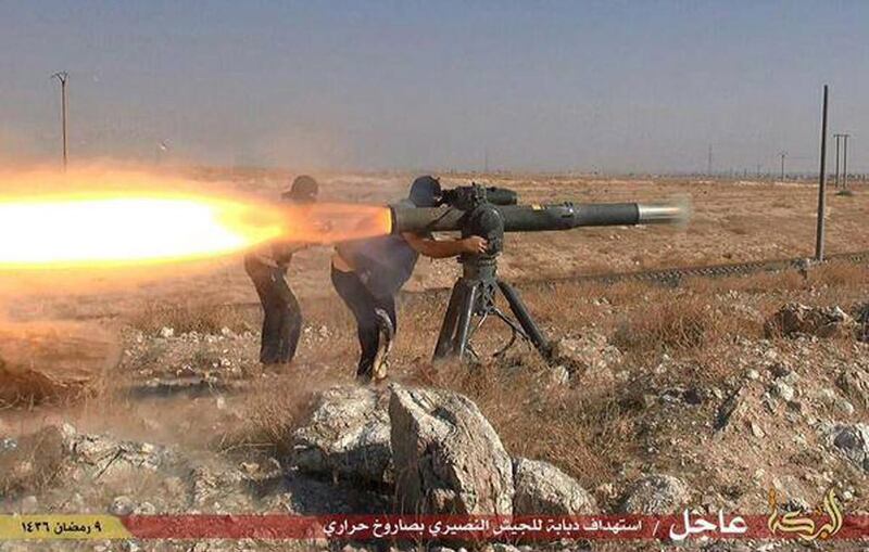ISIL militants fire an anti-tank missile in Hassakeh, north-eastern Syria. (Militant website via AP)