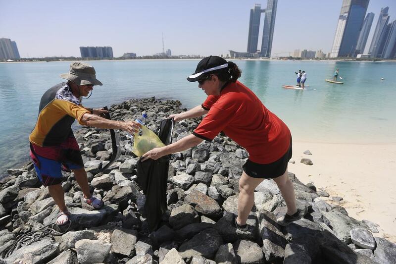 Volunteers from Paddlers for the Planet help clean up the Corniche / Sarah Dea