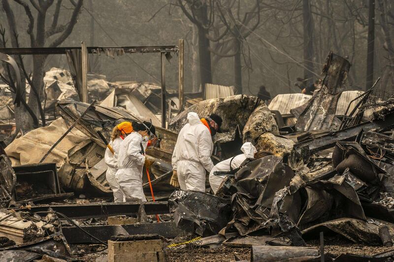 Search and rescue personnel from the Jackson County Sheriff's Office look for the possible remains of a missing elderly resident in a mobile home park  in Ashland, Oregon. AFP