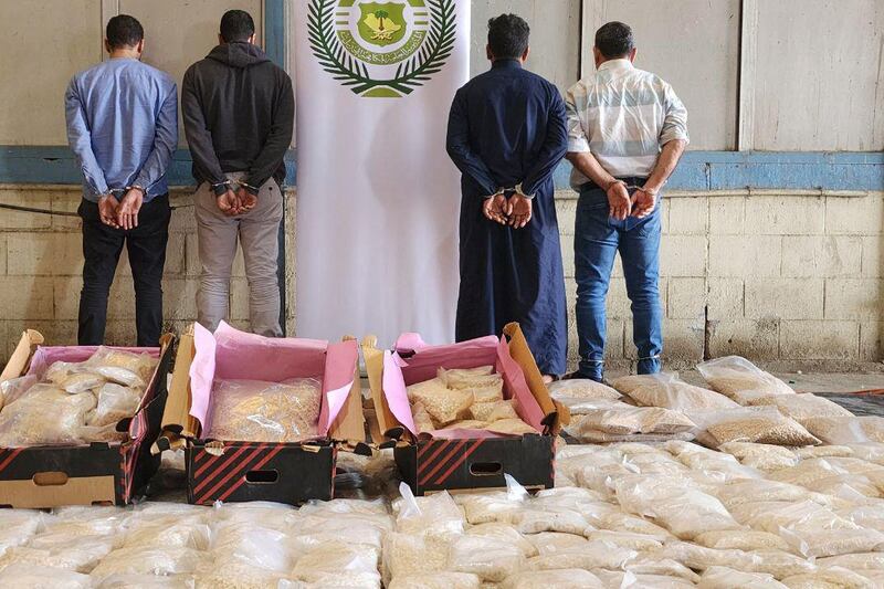 Handcuffed suspects and bags of drugs seized in Jeddah, where Saudi officials said they had thwarted an attempt to smuggle 12 million amphetamine pills. All photos: SPA