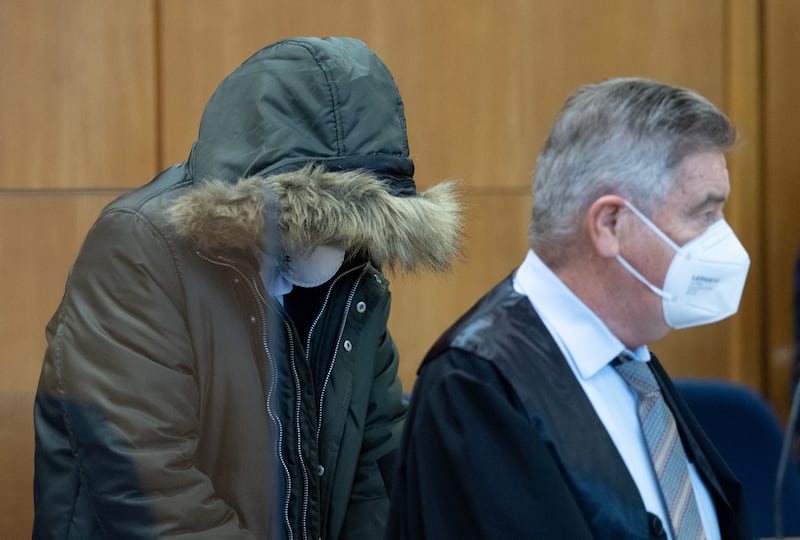 A Syrian doctor identified only as Alaa M, 36, with his head covered, goes on trial in Germany on January 19, accused of crimes against humanity. Reuters