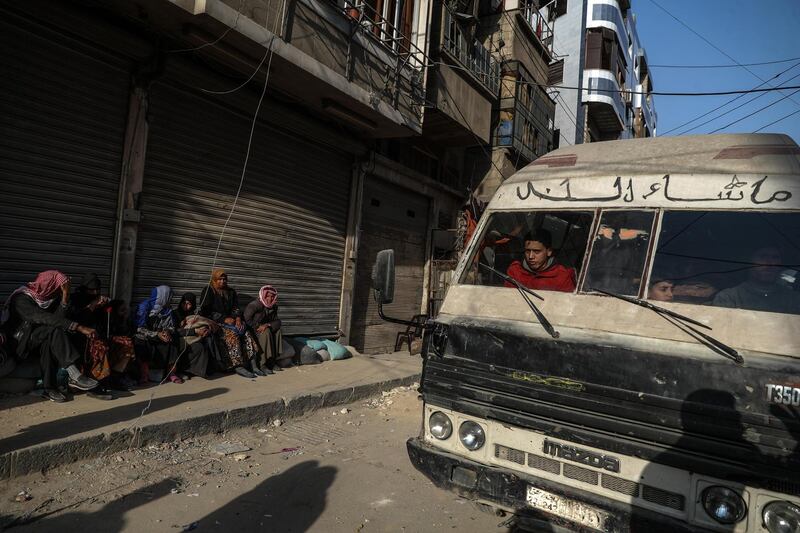 People wait for the bus to be evacuated in rebel-held Douma, Syria, on March 2018. Mohammed Badra / EPA