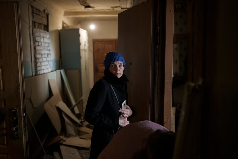 A woman walks through a damaged apartment building after a Russian attack in Kharkiv, Ukraine. AP