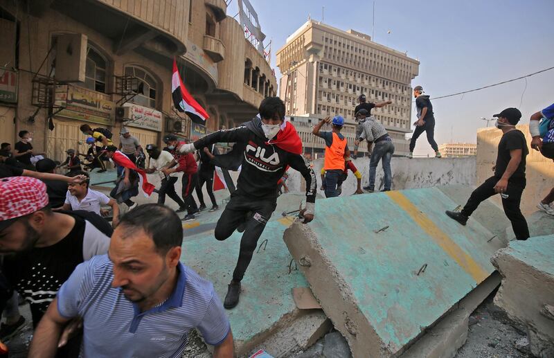 Iraqi protesters clash with Iraqi security forces at Baghdad's Khallani square during ongoing anti-government demonstrations on November 11, 2019.  AFP