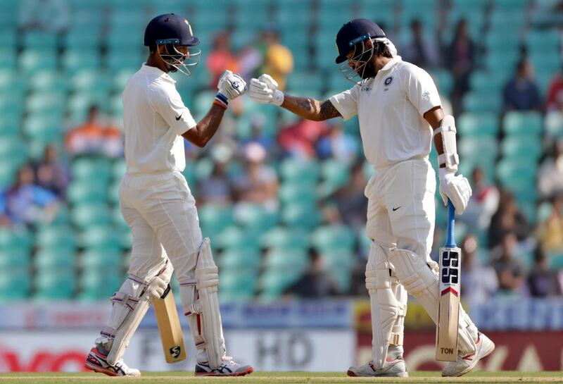 India's Cheteshwar Pujara, left, and Murali Vijay greet each other during the second day of their second test cricket match against Sri Lanka in Nagpur, India, Saturday, Nov. 25, 2017. (AP Photo/Rajanish Kakade)