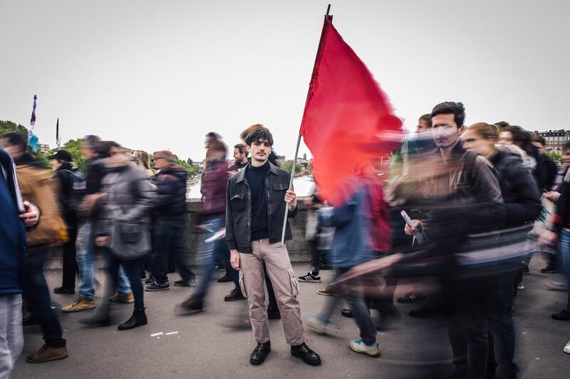 Remi Faussemagne, a 22 year old, student and cashier, poses for a photograph during the annual May Day workers' rally in Paris. AFP/LUCAS BARIOULET