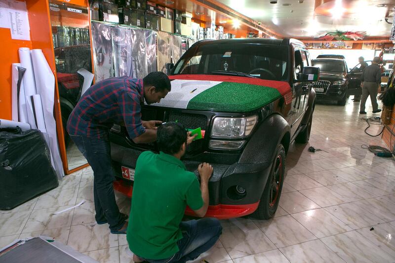 Abu Dhabi, United Arab Emirates -  November 28, 2016.  Car shops such as this are busy putting up some fancy decorations to celebrate the upcoming National Day.  ( Jeffrey E Biteng / The National )  Editor's Note;  ID 39806 *** Local Caption ***  JB281116-CarDeco01.jpg