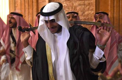 Saudi groom Basil Albani holds a traditional sword and dances with his friends during his wedding at his home in the Red Sea resort of Jeddah on September 6, 2018. It was a Saudi wedding like any other -- clutching a decorative sword, the groom bobbed and swayed in a traditional dance. But there was one striking difference -- a tiny guest list. Weddings in the oil-rich kingdom are typically lavish affairs, with a bulging guest list which is seen both as a social obligation and a symbol of affluence.
 / AFP / Amer HILABI
