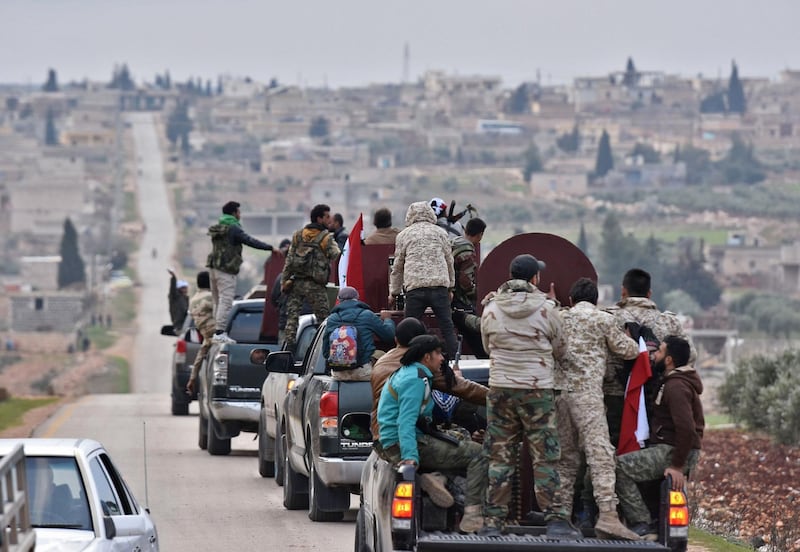 TOPSHOT - A picture taken on February 20, 2018 shows a convoy of pro-Syrian government fighters arriving in Syria's northern region of Afrin.
Kurdish forces said in a statement on February 20 that pro-regime fighters deployed to Syria's Afrin region will take up positions and "participate in defending the territorial unity of Syria and its borders", countering Turkey's offensive on the area. / AFP PHOTO / George OURFALIAN