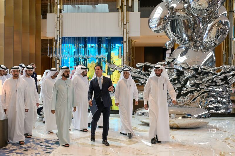 Sheikh Mohammed in the hotel's lobby with the sculpture Droplets in the background