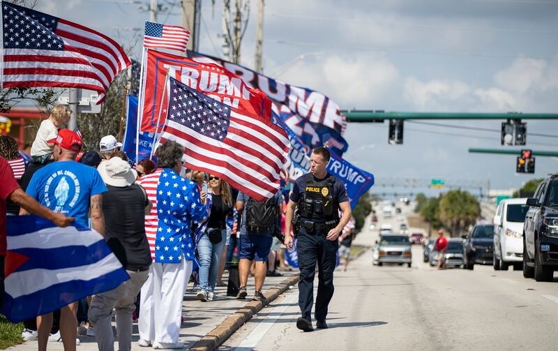 Trump supporters gather to see the former president's motorcade as it heads to Palm Beach International Airport. AP