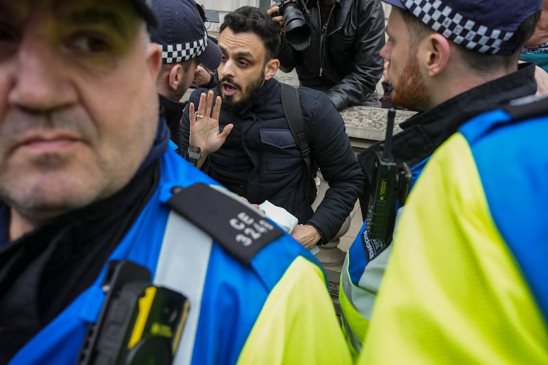 Police detain a protester at a pro-Palestine march in central London. PA