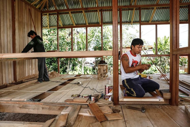 Woloan workers contruct a prefabricated wooden house. Orders have arrived from as far away as Argentina, Norway, Poland, Japan, South Korea, the Philippines and the United States for these simple traditional wooden houses. Putu Sayoga / Getty Images