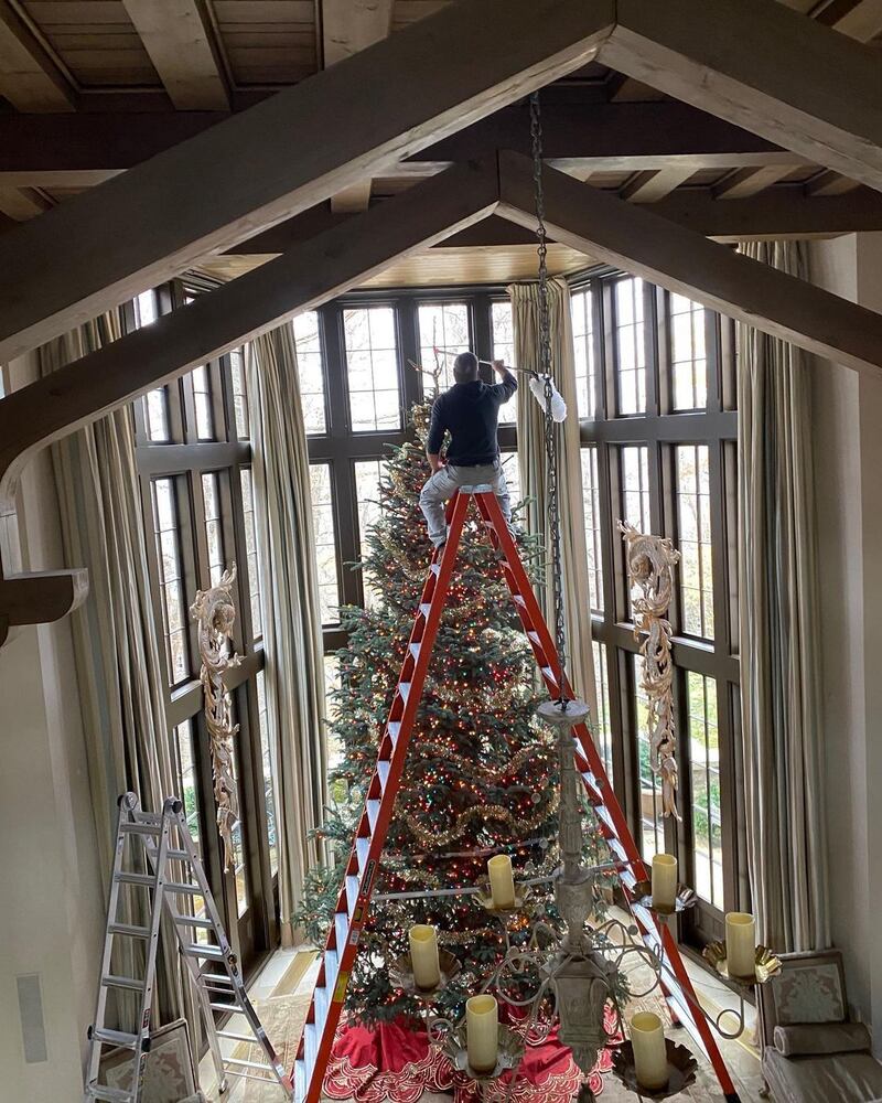 US country singer Tim McGraw showed that they take Christmas very seriously in the Tennessee house he shares with his wife, fellow country star Faith Hill. 'A: Santa's lead flying reindeer. B: wife trying to get rid of me before Christmas,' he joked on Instagram sharing a photo of their enormous tree and him at the top of a very steep ladder. Instagram