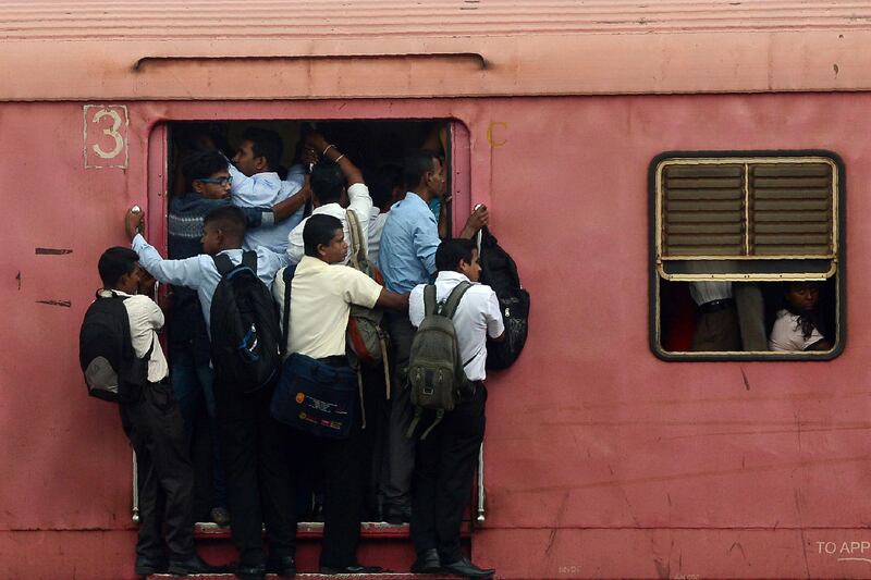 Passengers board a train in Colombo. Lakruwan Wanniarachchi / AFP Photo