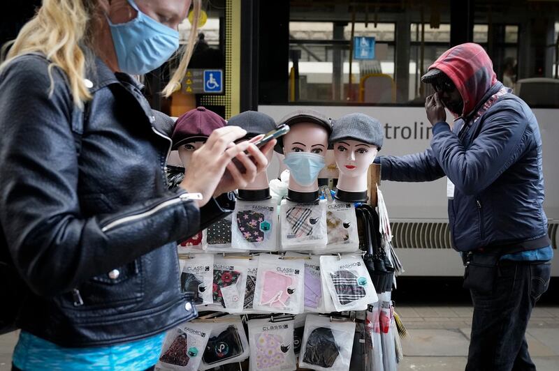 A street vendor sells face masks in Manchester, England. Getty Images