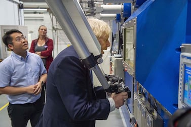 Britain's Prime Minister Boris Johnson gestures during his visit to the Fusion Energy Research Centre at the Fulham Science Centre in Oxfordshire, south east England. AFP