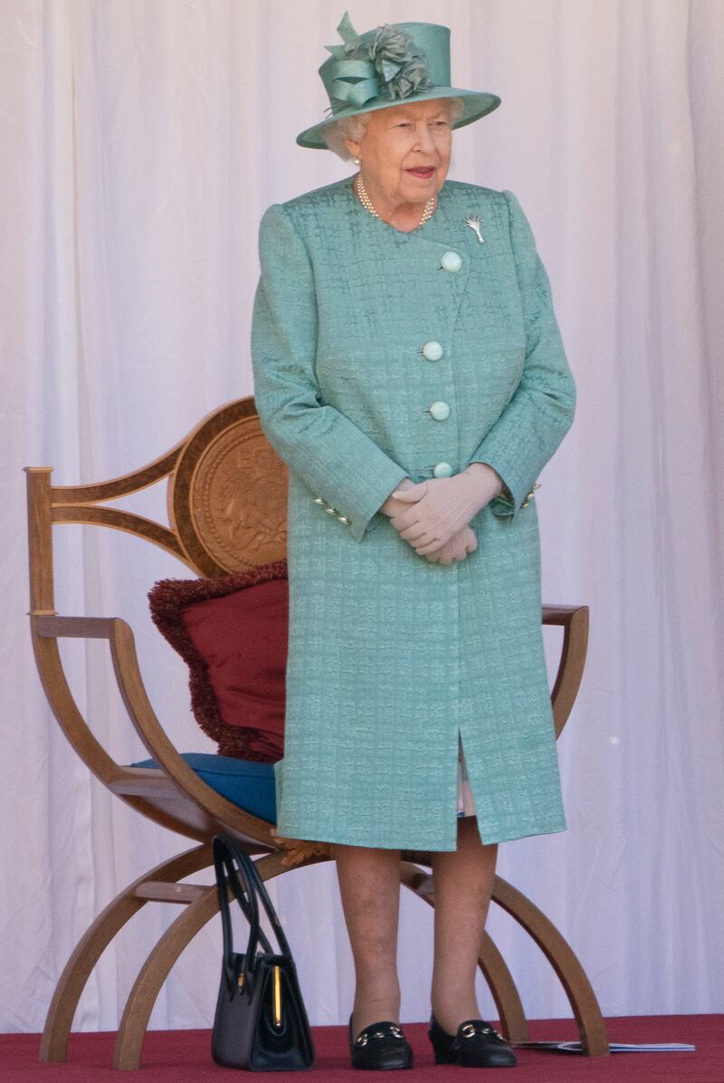 Queen Elizabeth II, in light green, attends a ceremony to mark her official birthday at Windsor Castle on June 13, 2020. Getty Images