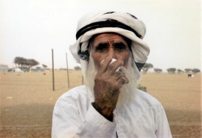 An elderly Omani man drinks coffee from a traditional cup. Photo: Jawad Ibrahim