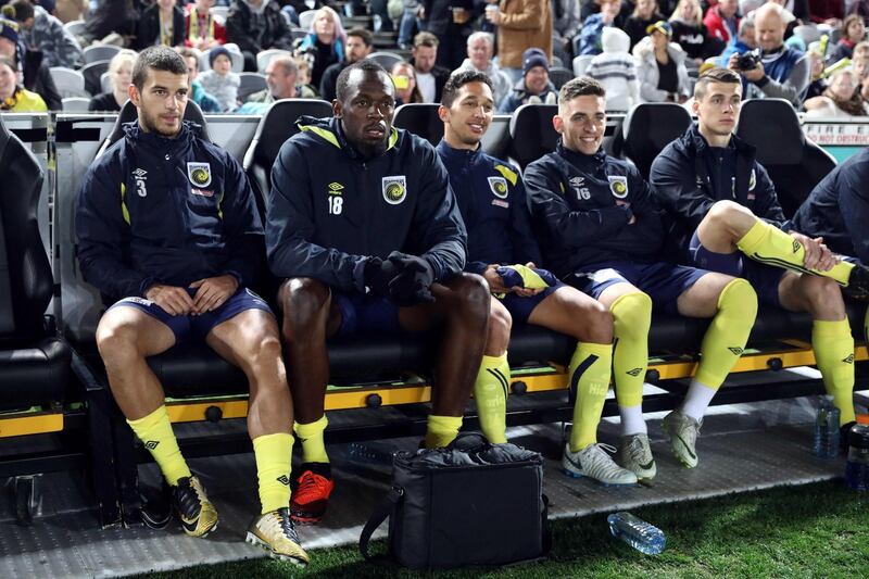 Usain Bolt sits on the bench ahead of his appearance for Central Coast Mariners during a pre-season friendly. AFP