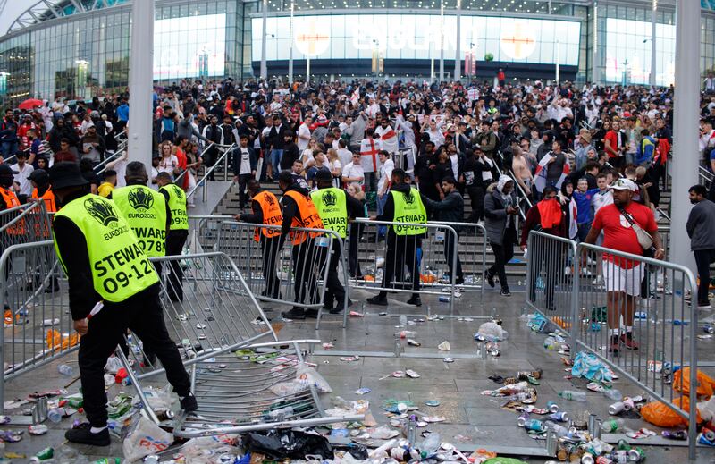 Stewards replace barricades outside Wembley Stadium in London, during the Euro 2020 final between England and Italy, outside which 6,000 people without tickets were planning to storm the stadium. AP