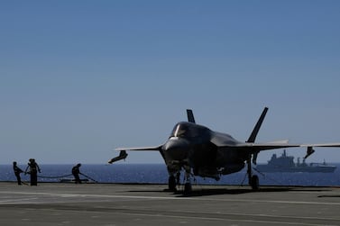 Crew members next to an F-35 aircraft on HMS Queen Elizabeth. AP