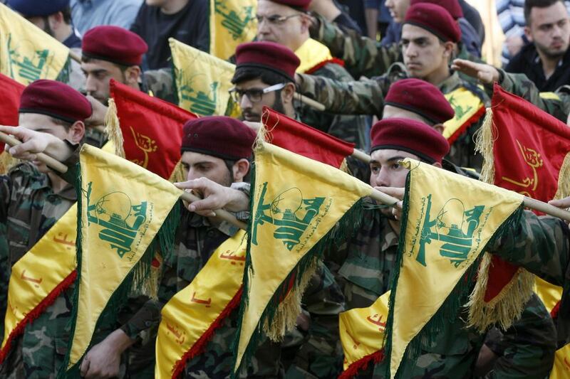 Members of Lebanon's Shiite movement Hizbollah hold their flags on March 1, 2016, in the southern town of Kfour, in the Nabatiyeh district, during the funeral of a Hizbollah fighter, Mohammed Hassan Nehme, who was killed while fighting alongside Syrian government forces in Syria. The GCC on Tuesday officially designated the group a terrorist group. Mahmoud Zayyat/ AFP