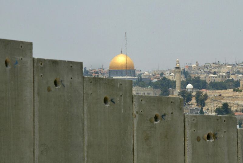 FILE - This July 9, 2004 file photo shows the golden shrine of the Dome of the Rock in Jerusalem's Old city can be seen behind a section made of concrete walls of the controversial separation barrier Israel is building in the village of Abu Dis in the outskirts of Jerusalem. In the 1948 war surrounding Israel's creation, Egyptian forces took control of the Gaza Strip and Jordan took over the West Bank and east Jerusalem. Israel captured the territories when it launched a surprise attack in 1967 at a time of soaring tensions with its hostile Arab neighbors.   (AP Photo/Enric Marti, File)