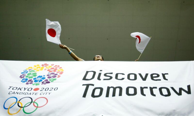 People celebrate after hearing that Tokyo had been chosen to host the 2020 Olympic Games during a public viewing event in Tokyo September 8, 2013. Tokyo was awarded the 2020 summer Olympic Games on Saturday following a vote by the International Olympic Committee. REUTERS/Toru Hanai (JAPAN - Tags: SPORT OLYMPICS) *** Local Caption ***  TOK105_OLYMPICS-202_0907_11.JPG