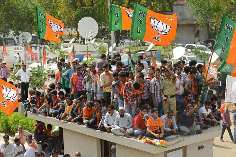 Supporters wait for the arrival of Narendra Modi at Shri Kamalam, the BJP Gujarat’s new headquarters in Gandhinagar. By Friday evening, the Bharatiya Janata Party was winning in enough seats in the lower house of Parliament to exceed the 272-seat majority needed to create a government without forming a coalition. Sam Panthaky / AFP / May 16, 2014