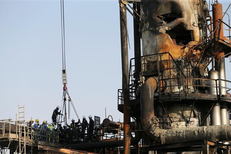 Workers are seen at the damaged site of Saudi Aramco oil facility in Abqaiq. Reuters