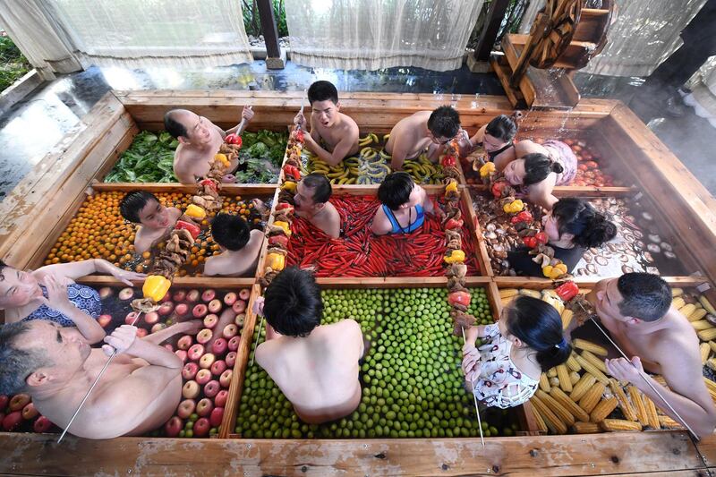 People enjoy a barbecue as they bathe in a hot spring filled with fruit and vegetables at hotel in Hangzhou, Zhejiang province, China. Reuter