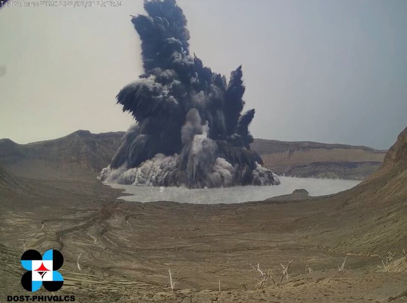 A phreatomagmatic eruption plume billows from Taal volcano in this screen grab obtained from a social media video.