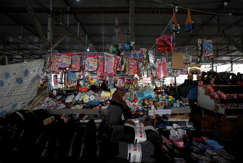 A local walks past plastic toys displayed for sale at a market in Ramallah, in the occupied West Bank. Reuters