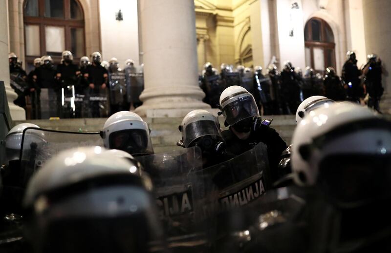 Riot police stand in formation outside the parliament building in Belgrade, Serbia, on Friday. Reuters