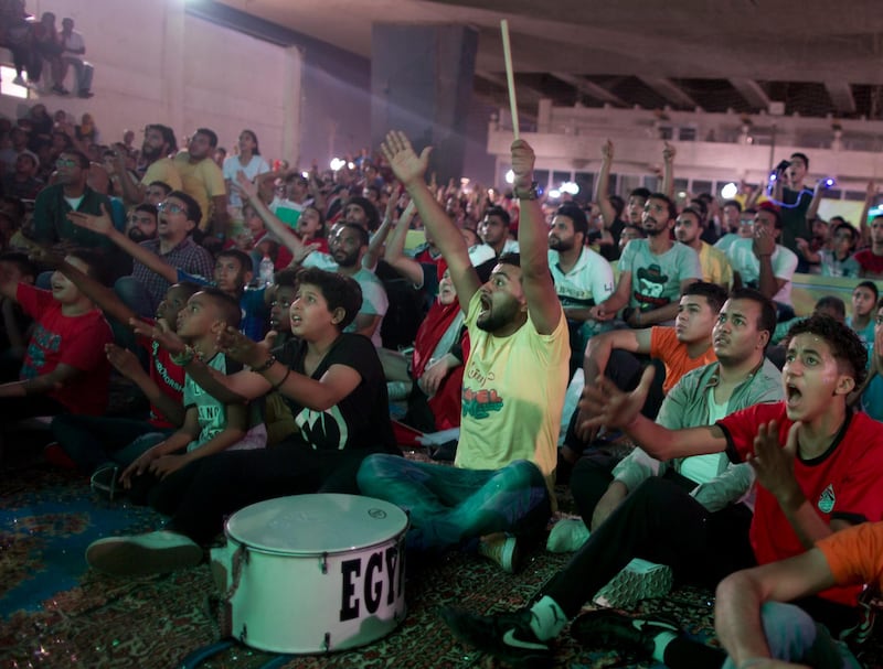 Egyptian fans shouts as they watch the group A World Cup match between Egypt and Russia on a giant screen at Al Jazera youth club, in Cairo, Egypt, Tuesday, June 19, 2018. Russia scored three goals in a 15-minute span early in the second half to set up a 3-1 win over Egypt on Tuesday, moving the host nation to the brink of the World Cup's knockout stage. (AP Photo/Amr Nabil)