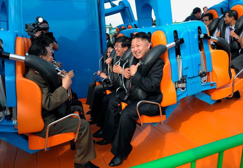 Kim Jong-un enjoys the ride as he attends the completion ceremony of the Rungna People's Pleasure Ground in Pyongyang in July 2012. KCNA / AP