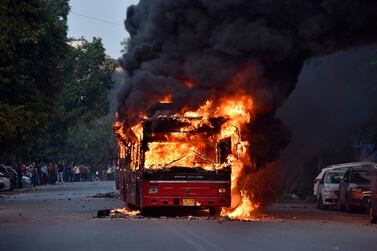 A bus on fire is pictured following a demonstration against the Indian government's Citizenship Amendment Bill (CAB) in New Delhi on December 15, 2019.  AFP / STR