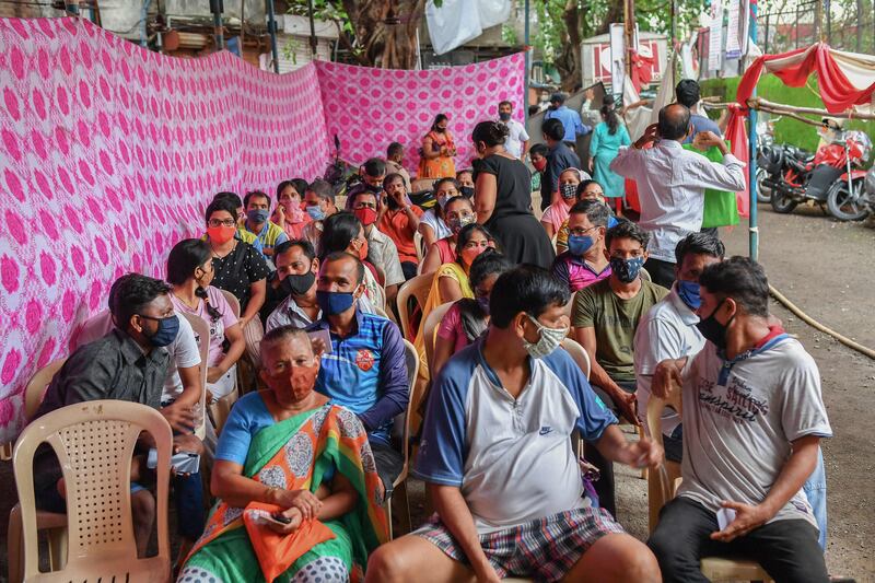 Residents await the arrival of doses of the Covishield vaccine in Mumbai, India.
