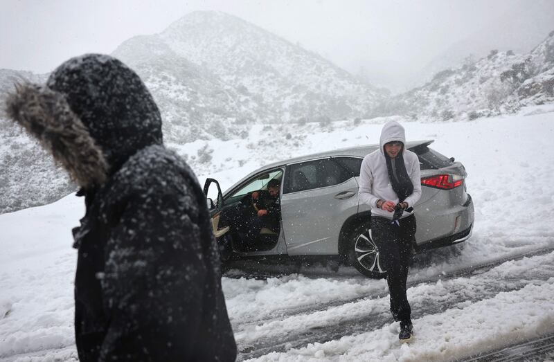 A car gets stuck in the snow on a roadway in the San Gabriel Mountains in Angeles National Forest. AFP