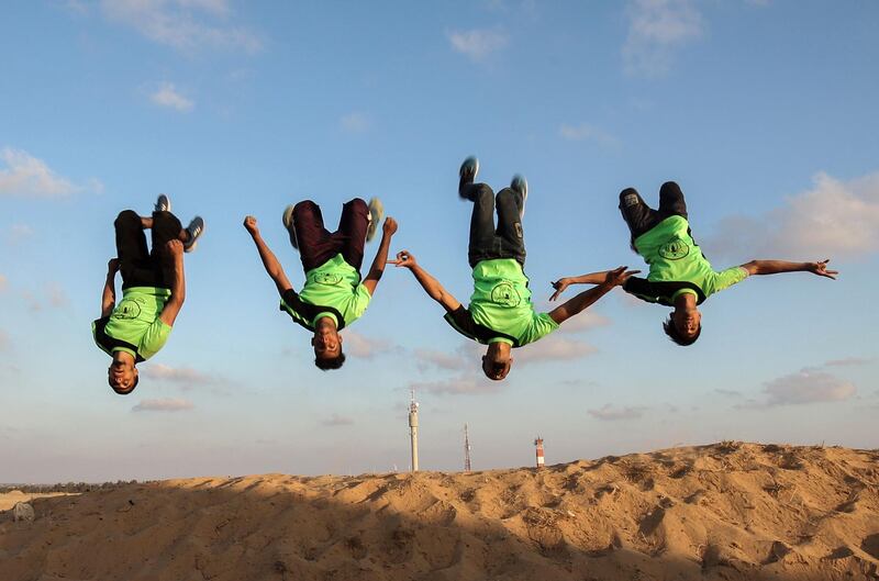 Palestinian youths practice their parkour skills at the Israel-Gaza border in the southern Gaza Strip. Said Khatib / AFP