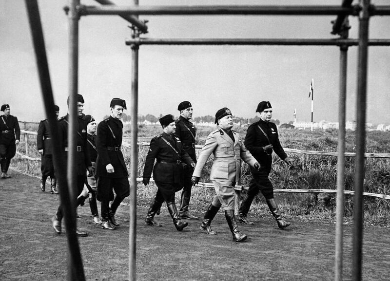 The EUR is a neighbourhood created by Benito Mussolini, seen visiting a construction site in Rome in 1937, to glorify his fascist regime. Alamy