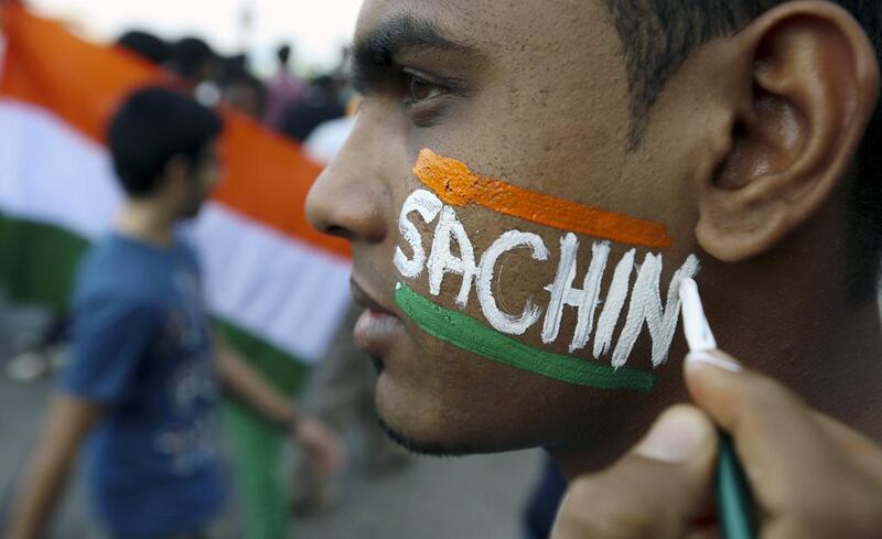 A fan gets his face painted with Sachin's name on Thursday. Divyakant Solanki / EPA